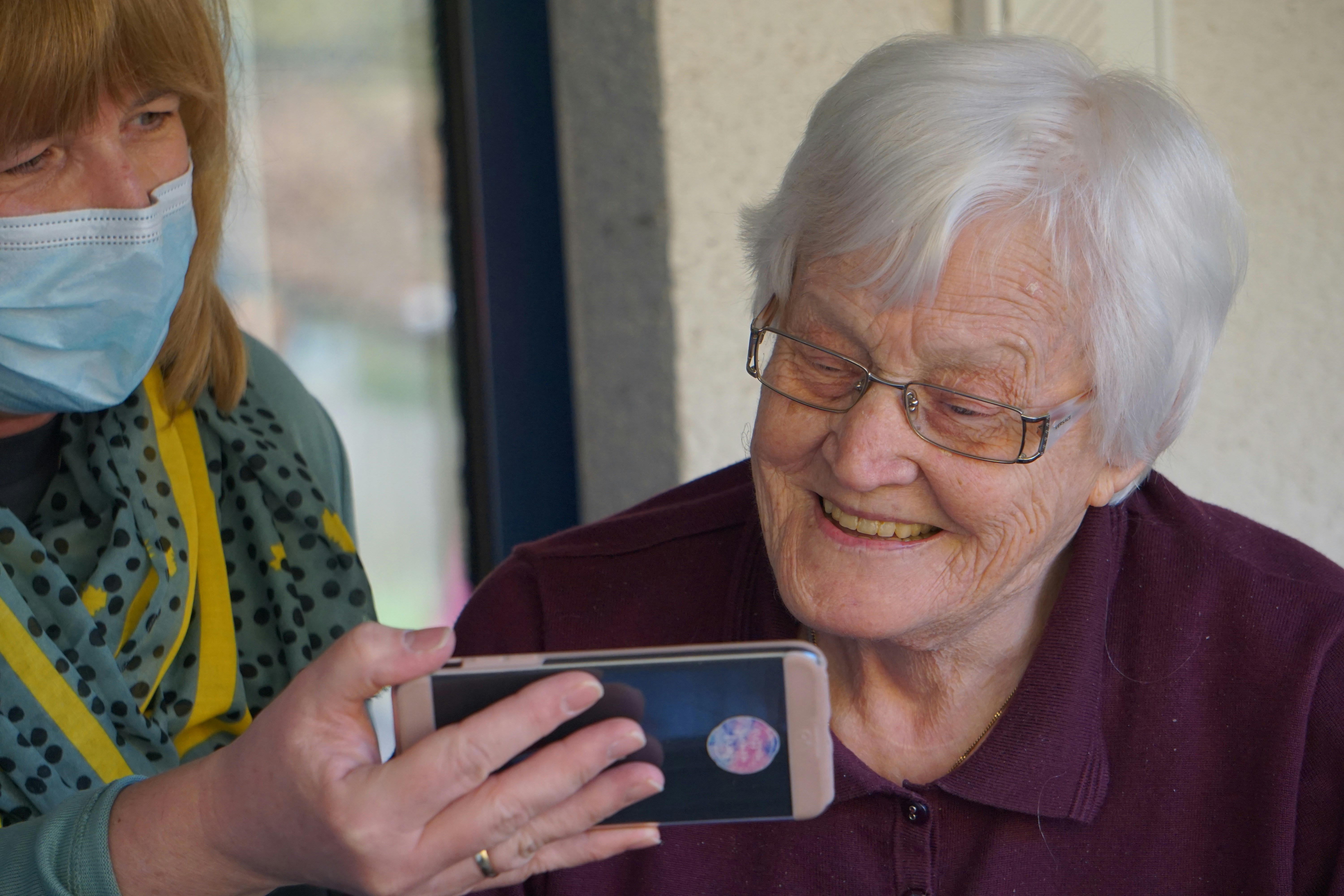 Picture of and eldary lady looking at a mobile device